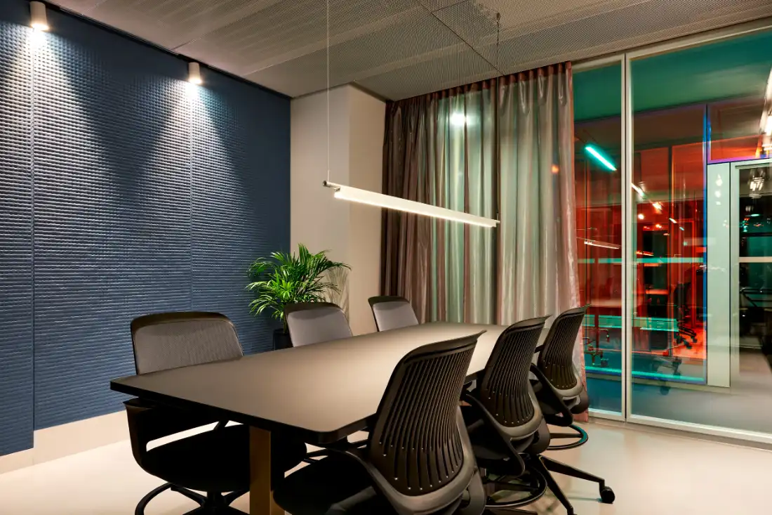 Boardroom with a textured blue wall and a view over Berlin at dusk